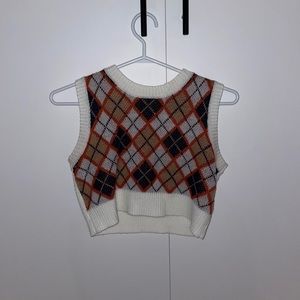 Knit white, orange and blue crop top.